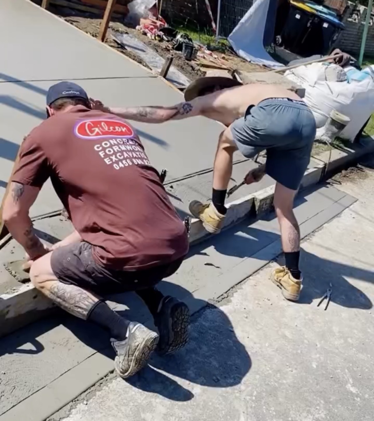 Gilcon team members hand-finishing a fresh concrete slab on site