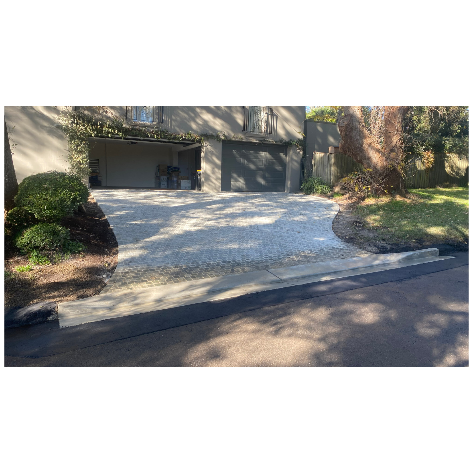 Cobblestone paved driveway with a new concrete vehicular crossing to the street