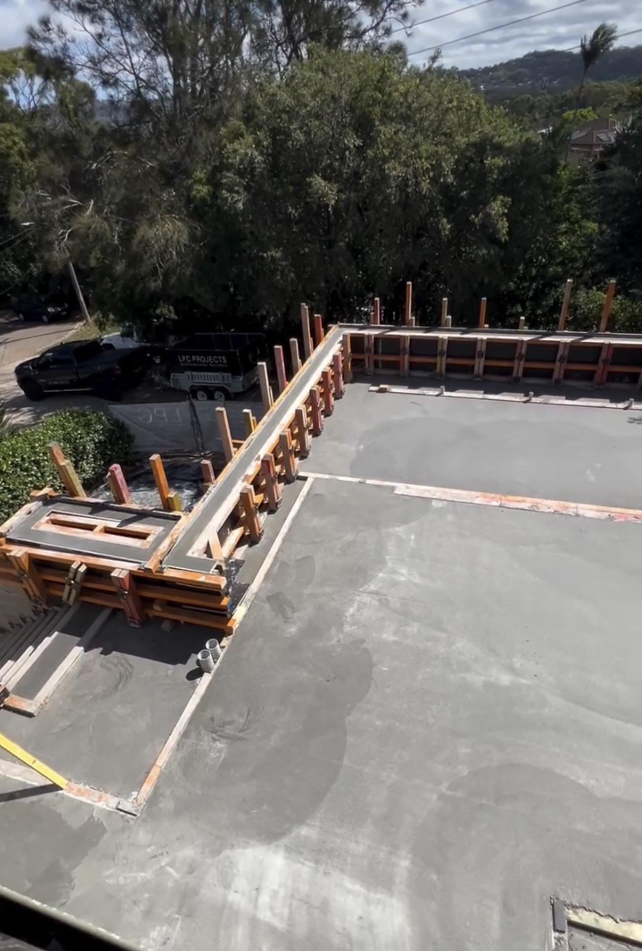 Freshly poured and finished suspended concrete slab with wall formwork