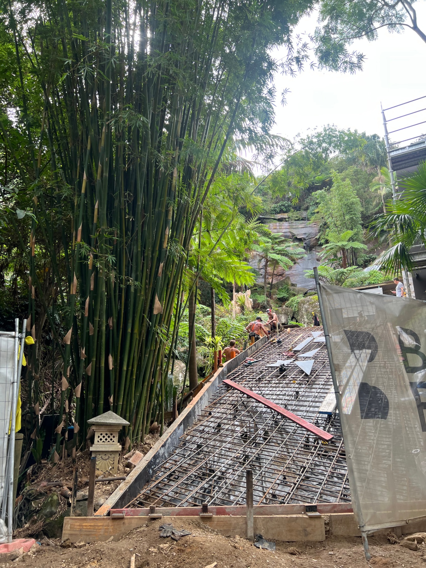 Steel reinforcement and formwork for a sloping slab pour beside bushland